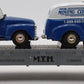 MTH 30-7647 O Gauge Auto Flatcar with 2 Ertl 1950 Panel Trucks NIB