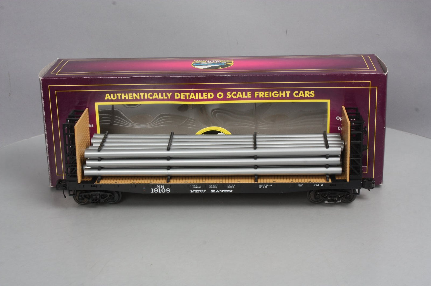 MTH 20-98665 New Haven Flat Car w/Bulkheads & Pipe Load